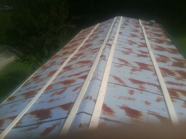 Rusted metal roof panels with new wood purlins before replacement — Storm Damage Roof Repair in Bedias by Roofing Brothers